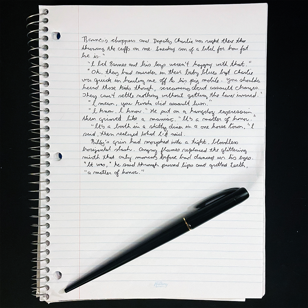 an a4 spiral notebook with half a page of cursive handwritten text and a black fountain pen
